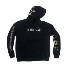image of the front of a black pullover hoodie on a white background. hoodie has a cream center chest print that says lilith czar. the left sleeve says created from filth and dust and the right sleeve has three symbols.
